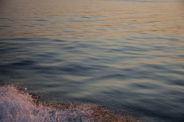 Rippling waves illuminated by setting sun over Long Island Sound in New England