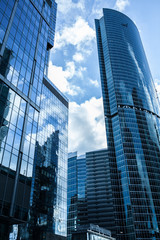 Fototapeta na wymiar Detail blue glass building background with cloud sky