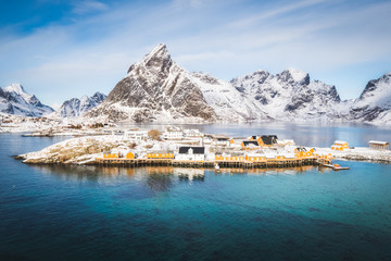 Beautiful fishing village Sakrisoy on Lofoten islands is covered with snow.