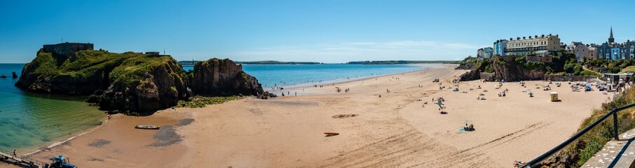 Panoramic view of a large sandy beach with small offshore island (Castle Beach, Tenby, Wales)