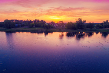 View of countryside and lake in evening.