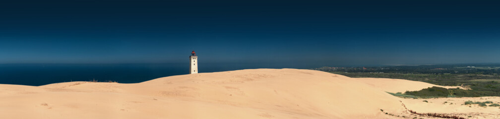 Panorama view of a danish landscape sand dunes with famous lighthouse. Rubjerg Knude Lighthouse, Lønstrup in North Jutland in Denmark, Skagerrak, North Sea