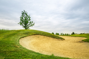 Trimmed field and sand bunkers on golf course