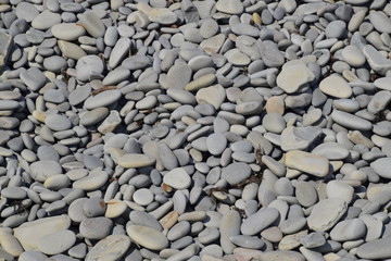 Sea pebbles background texture. The stone of the sea beach.
