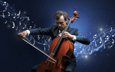 Fototapeta premium Lonely musical composer with cello and sparkling musical notes around