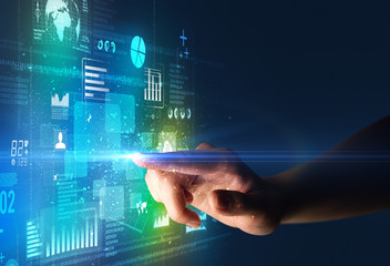 Female finger touching a beam of light surrounded by blue and green data and charts