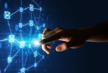 Female finger touching a beam of light surrounded by a blue graphic with envelopes