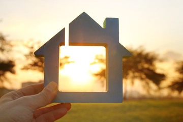 Image of vintage house in the grass, garden or park at sunset light.