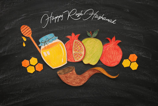 Rosh hashanah (jewish New Year holiday) concept. Traditional symbols shapes carved from paper and painted.