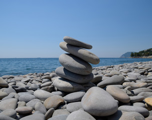 Fototapeta na wymiar Stones stacked on top of each other against the background of the sea