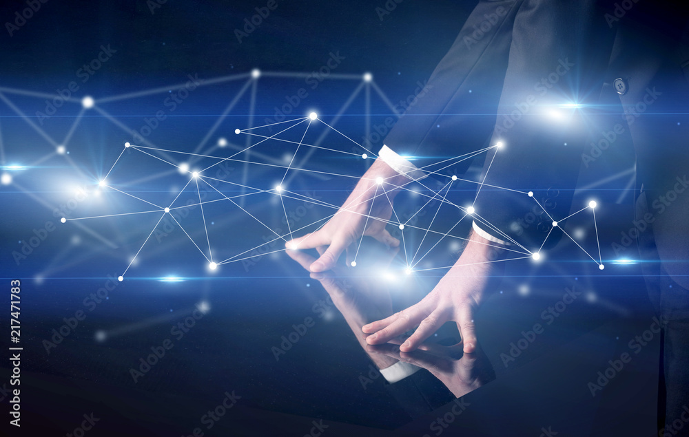 Poster male hands touching interactive table with blue connectivity graphic in the background