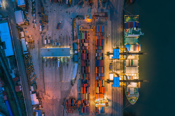 Aerial top view of ship containers at shipping port for international import or export logistics or transportation business concept background.
