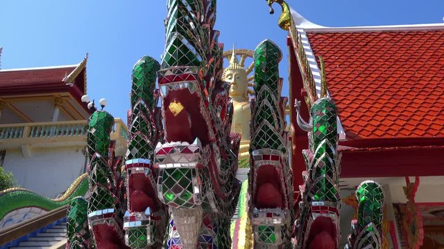 Panoramic view of statue of seven-headed Naga or Mucalinda protecting Buddha while meditating. Buddhist sculpture depicting mythological creature or deity at Wat Phra Yai, Koh Samui island, Thailand.
