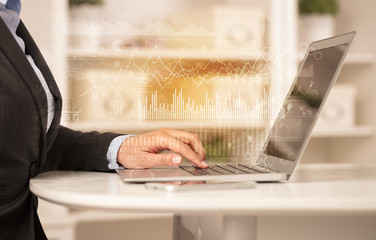 Business woman in homey environment using laptop with global financial report concept
