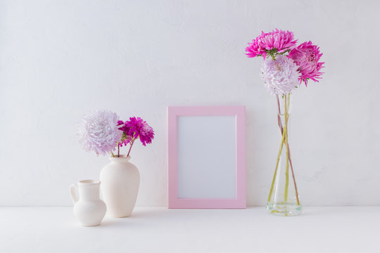 Mockup with a pink frame and pink flowers in a vase