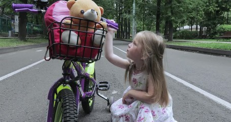 Girl child repairs bicycle