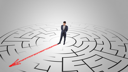 Businessman going through the maze with red arrow
