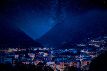 Fototapeta premium Mountain village under Milky Way night sky