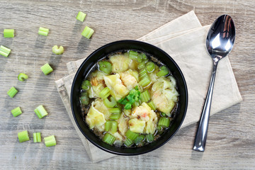 wonton clear soup with celery, traditional asian food