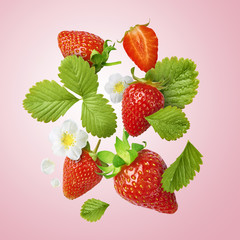 Flying Fresh tasty ripe strawberry with green leaves isolated