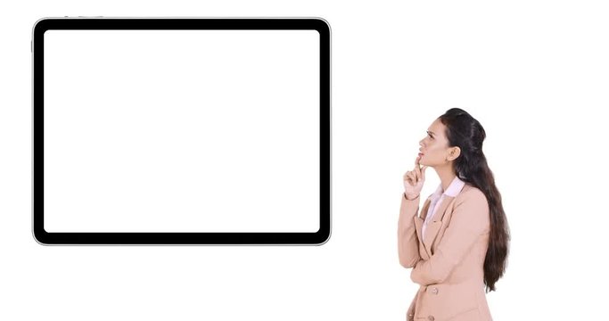 Young business woman thinking idea while looking at empty whiteboard for copy space in the studio. Shot in 4k resolution