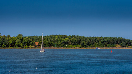 Fototapeta na wymiar Lonely sail boat by the shore