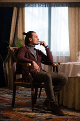 man in the room sitting in a chair 