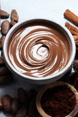 Melting chocolate  or melted chocolate with a chocolate swirl. Many stack and chips with powder.