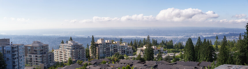 Aerial view of residential homes and buildings on top of Burnaby Mountain. Taken in Vancouver, British Columbia, Canada.