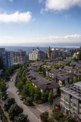 Aerial view of residential homes and buildings on top of Burnaby Mountain. Taken in Vancouver, British Columbia, Canada.