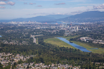 Aerial view of Burnaby Lake in the City with Downtown in the background. Taken in Vancouver, British Columbia, Canada.