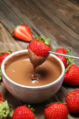 Fondue with Melting chocolate or melted chocolate and strawberry.