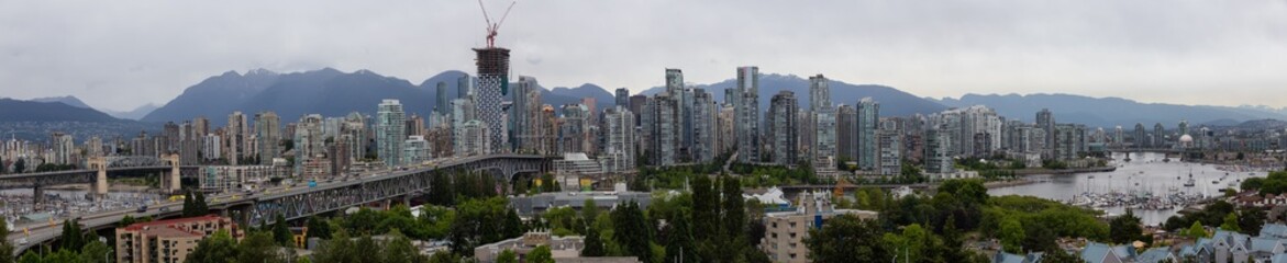 Fototapeta na wymiar Aerial panoramic view of Downtown City during a cloudy summer evening before sunset. Taken in Vancouver, British Columbia, Canada.