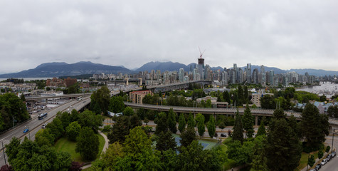 Aerial panoramic view of Downtown City during a cloudy summer evening before sunset. Taken in Vancouver, British Columbia, Canada.