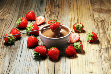 Fondue with Melting chocolate or melted chocolate and strawberry.