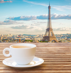 cup of coffee with view of famous Eiffel Tower landmark and Paris old roofs, Paris France, toned