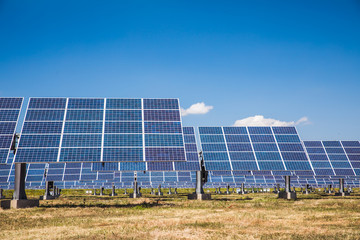 Group of solar panels on a blue sky with clouds