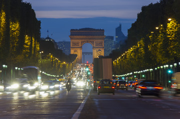 sunset scene in Paris city. Long exposure photo of street traffic near Arc de Triomphe, Champs Elysees boulevard.