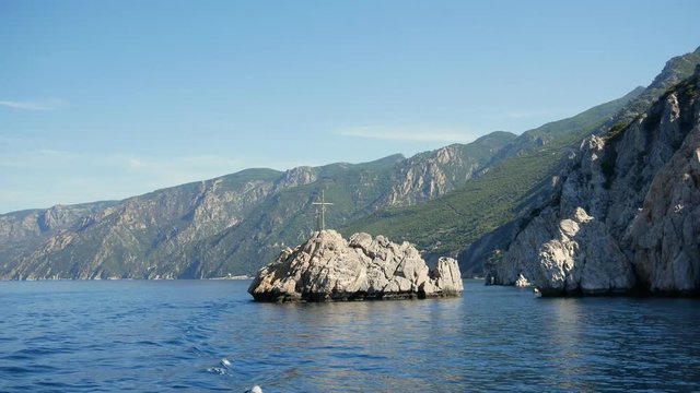 Aegean Sea and cross on rock next to Mount Athos