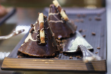 Chocolate cake with white chocolate shaving on a silver tray