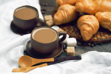 A cup of coffee and croissants on a white background