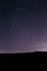 Naklejka premium Blue dark night sky with many stars. Milky way cosmos background. The stars in the night sky. Starry blue night sky. Night scape with beautiful starry sky. Star texture. Space background