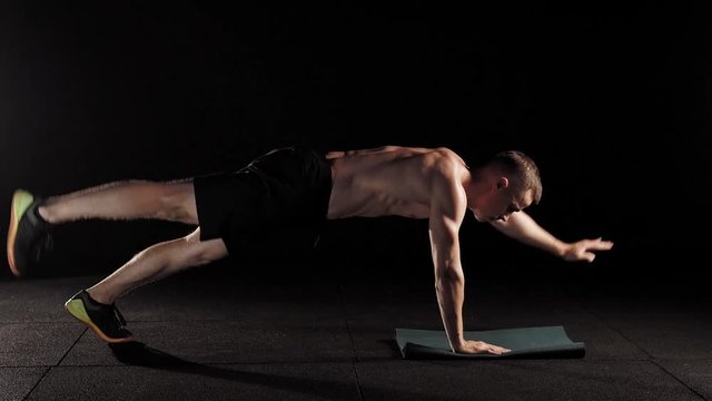 Athlete Doing A Bird Dog Plank On A Mat Half Naked.