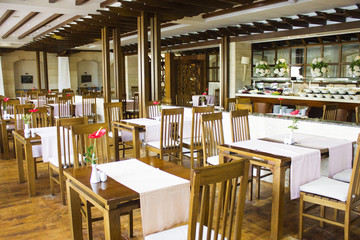 Cozy cafe with a buffet with wooden tables and chairs