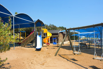 Wooden swing and children's playground on the beach