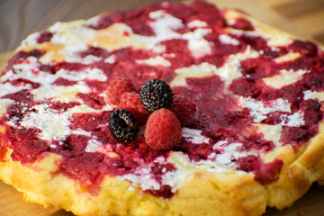 Cheesecake with raspberries and blackberry close-up. Light breakfast.