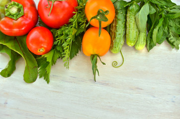 fresh tomatoes and peppers, cucumbers and celery and Basil on wooden 