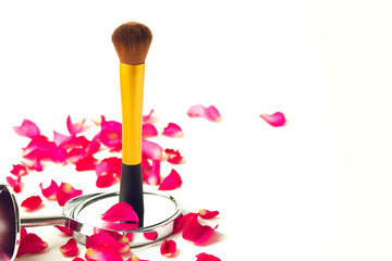 gold makeup beauty cosmetic brush with mirror with rose petals flower red on white background