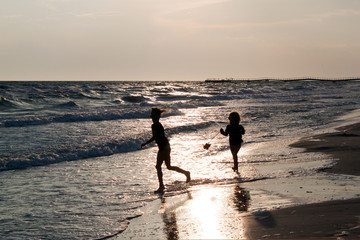 Fototapeta na wymiar young girls running on the sea coast childhood