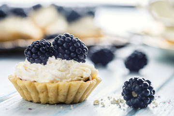 Mini tartlets with blackberries whipped cream and coffee.